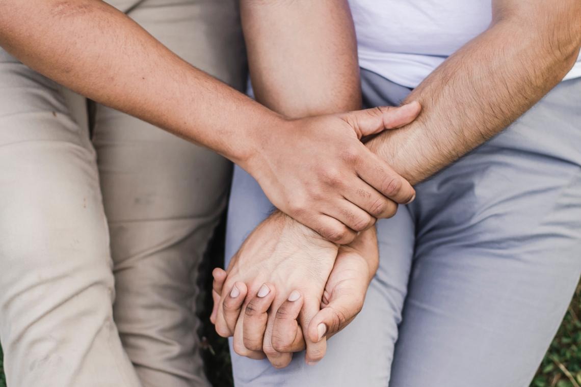 two peoples hands holding