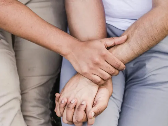 two peoples hands holding