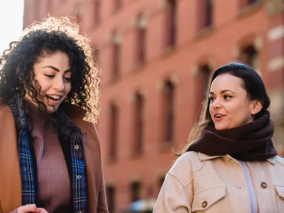 two people walking outside and talking