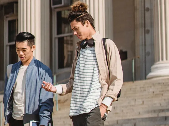 Two Men Standing Outside A University Building